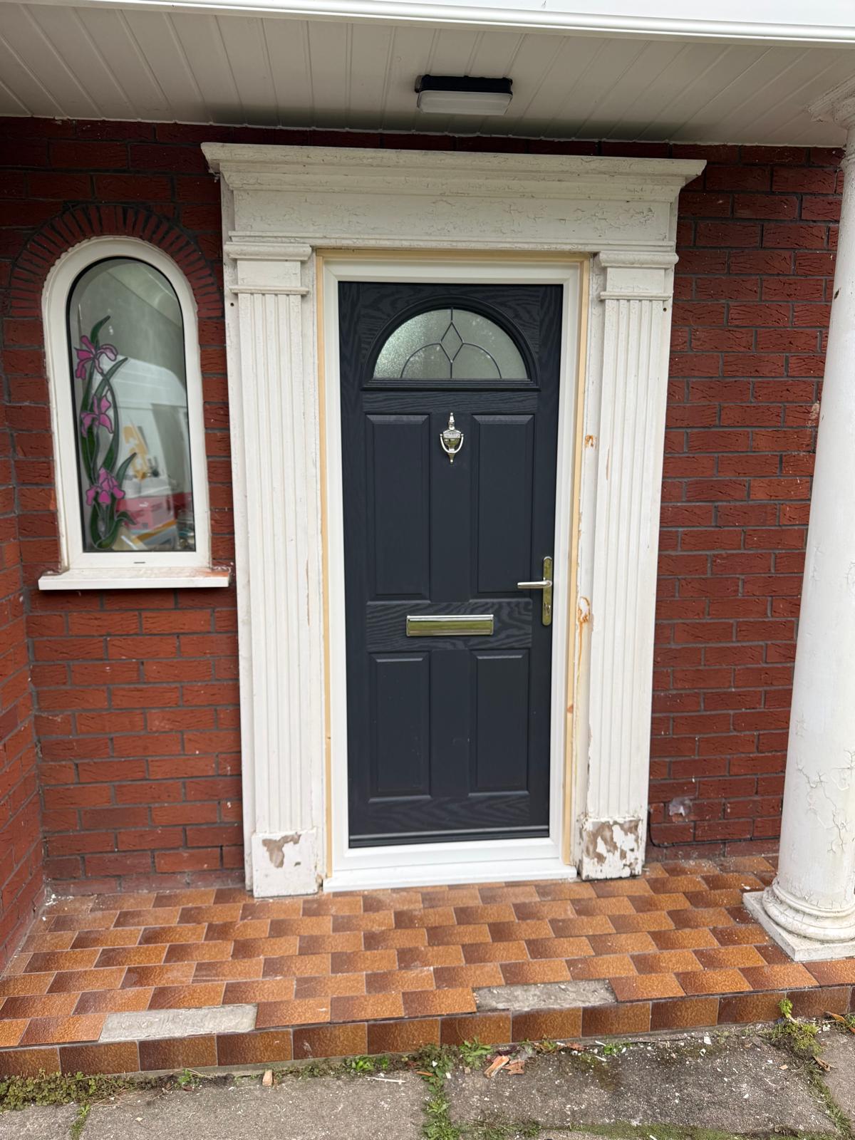 Dark composite entrance door with decorative glazing and white frame - New Composite Door Install North Wales